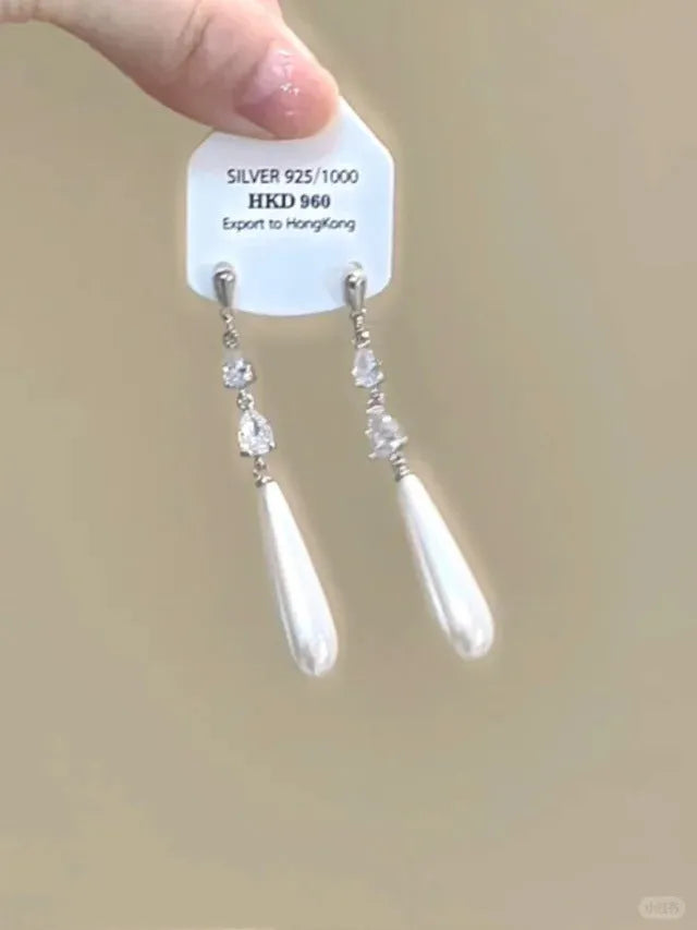 Geometric alloy clip-on earrings with rhinestone stars, a heart design, and dangling tassels.