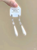 Geometric alloy clip-on earrings with rhinestone stars, a heart design, and dangling tassels.