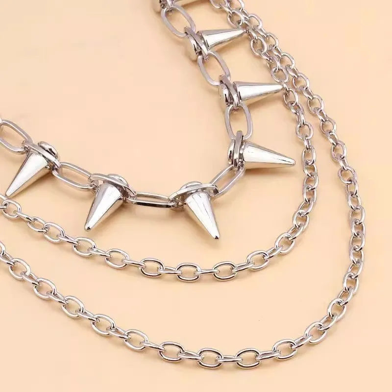 Silver metal pants chain with double layer design and punk rivet ornaments on dark background