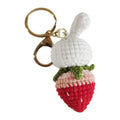 Hand-woven white rabbit and strawberry cartoon pendant on a key, made from braided doll wire.