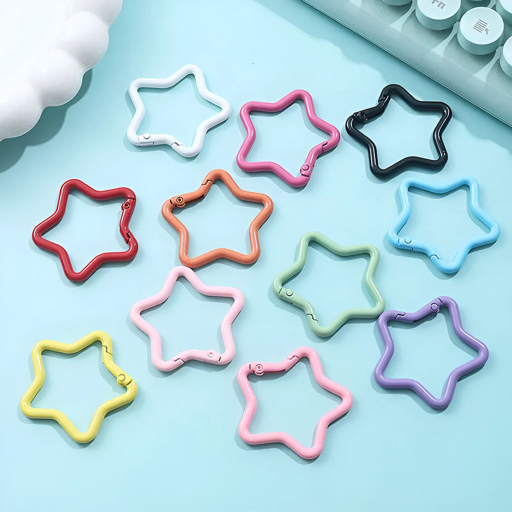 Zinc alloy five-pointed star keychain in assorted macaron colours including pink, blue, and purple