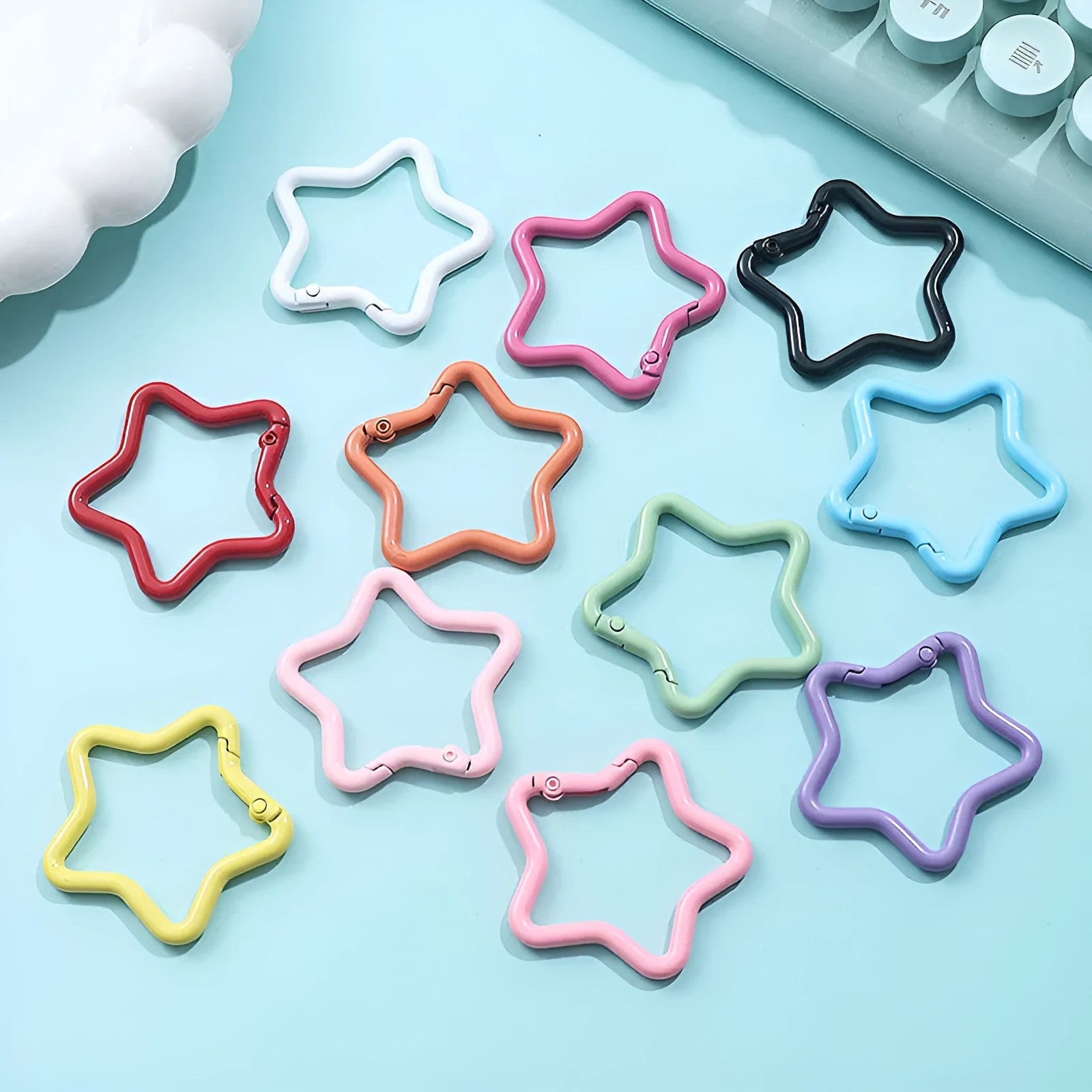 Zinc alloy five-pointed star keychain in assorted macaron colours including pink, blue, and purple