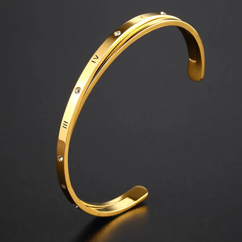 Open-ended stainless steel bracelet for women with inlaid zircon stones, shown in gold colour.