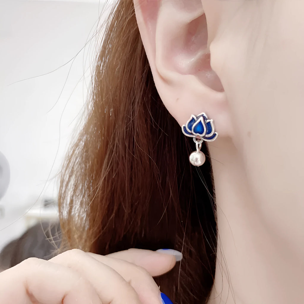 Blue alloy lotus seedpod earrings with tassel detail, shown as a pair of dangle drop studs.