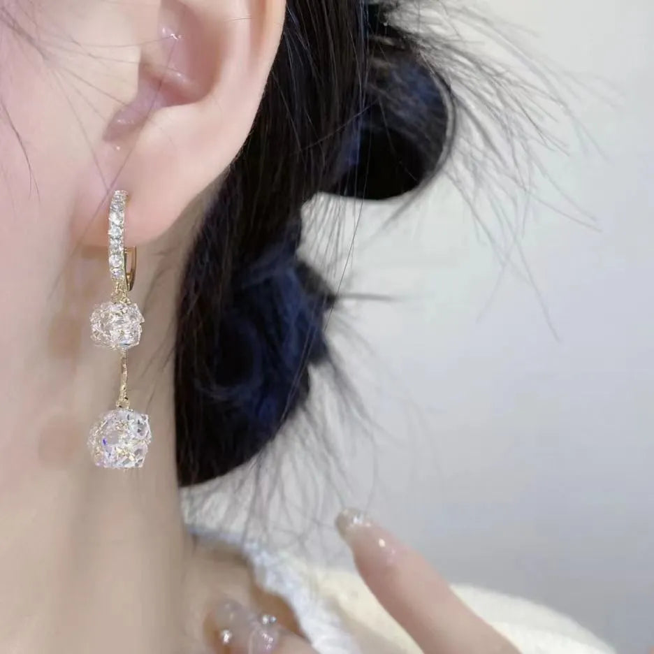 Women's silver drop earrings with confession balloon and rhinestone ball pendants and tassel detailing