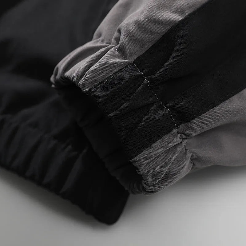 Men's black casual jacket with contrast colour stitching detail on the front, showing side seam pockets.