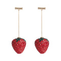 Geometric strawberry-shaped alloy earrings with spot-drill texture, shown in red colour.