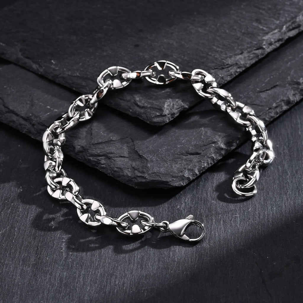 Men's stainless steel geometric link chain bracelet showing thick handmade construction