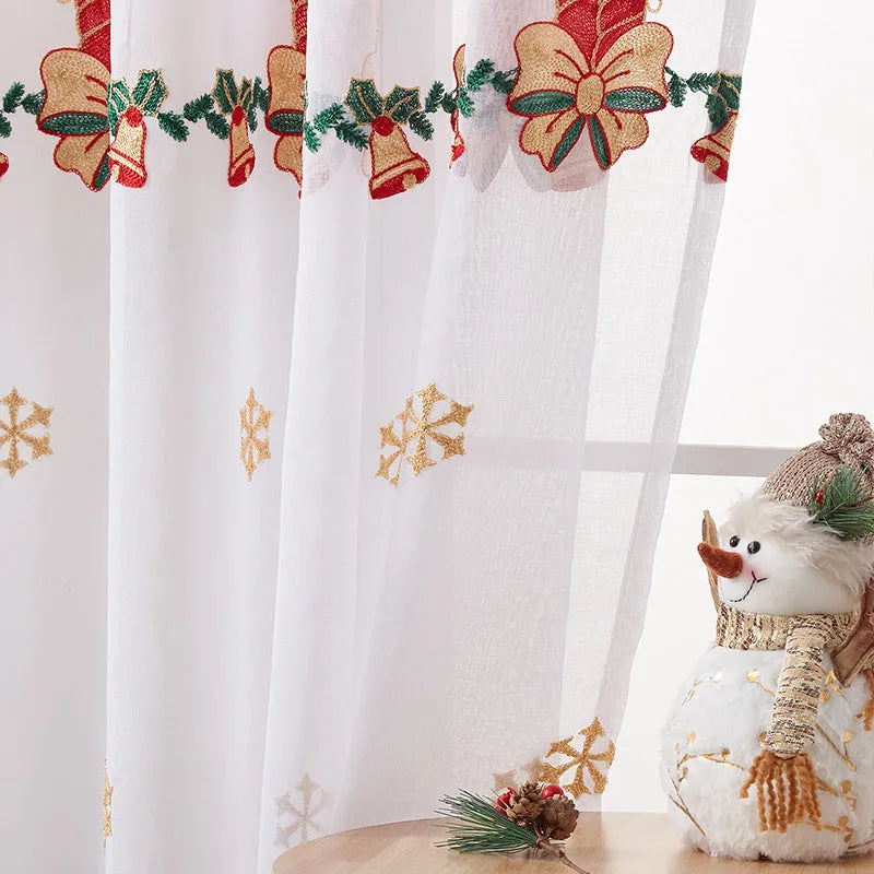Christmas curtains with white snowflake embroidery on red polyester fabric hanging in window