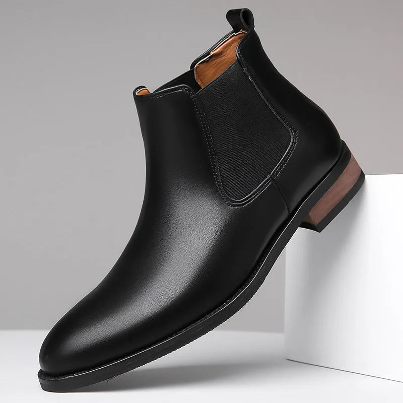 Men's black Chelsea boots with round toe, low heel, and mid-calf shaft made from artificial PU leather