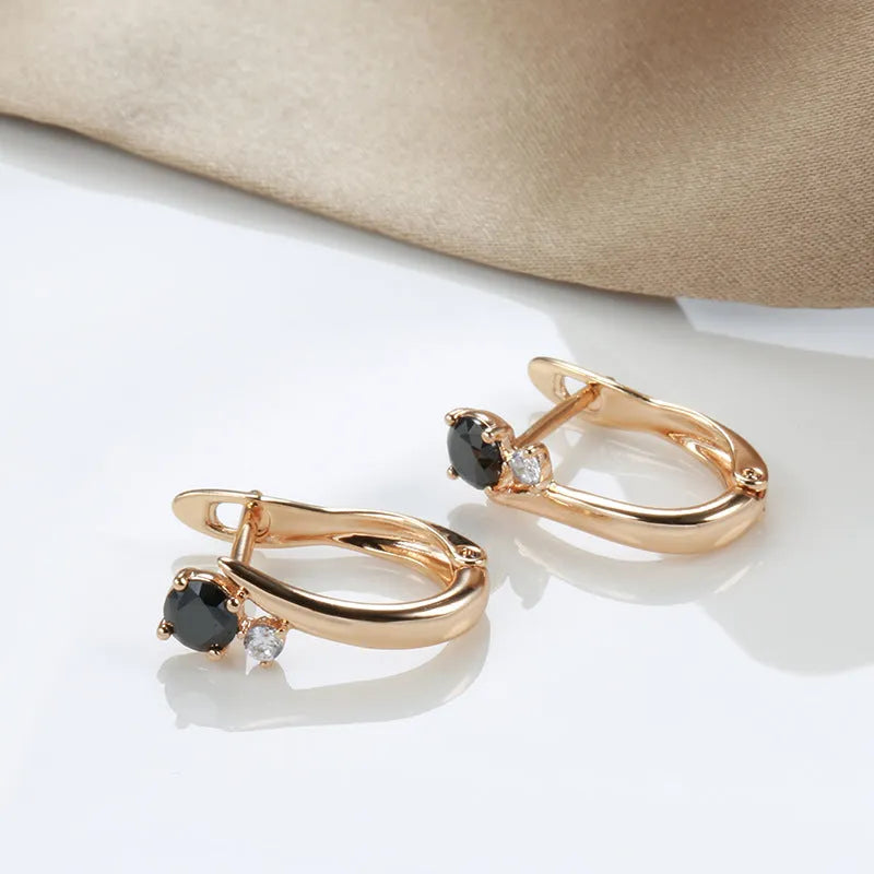 Women's drop shape earrings with black agate stones and gold-plated copper geometric design