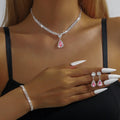 Women's rhinestone water drop necklace and earrings set on a claw chain in blue colour.