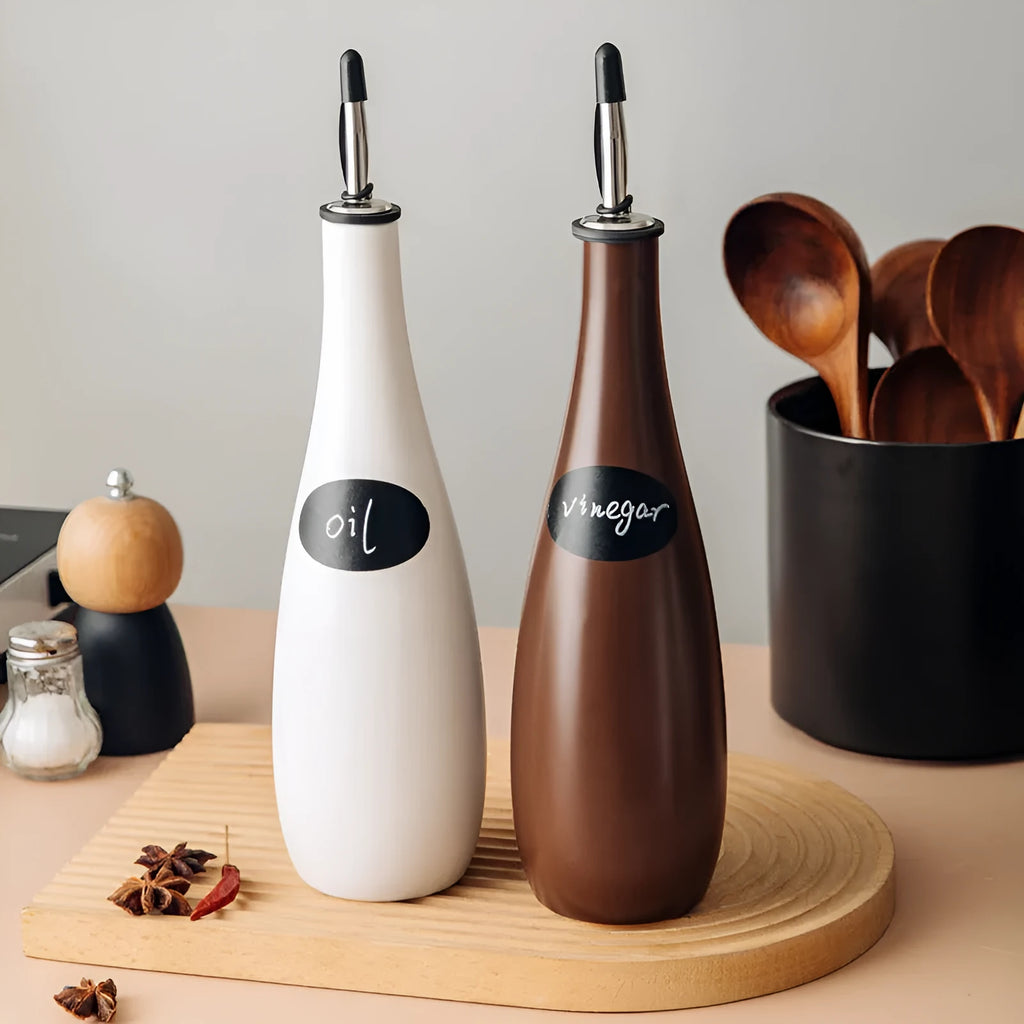 Ceramic oil pot with funnel lid and integrated brush in kitchen setting