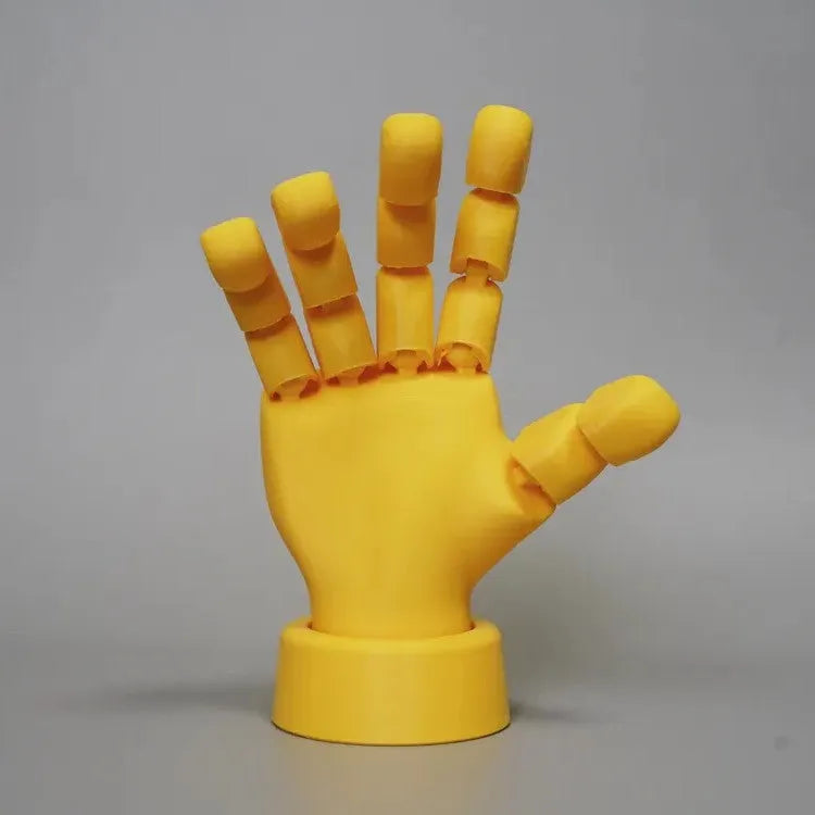 Yellow movable joint hand prop ornament with articulated fingers on white background