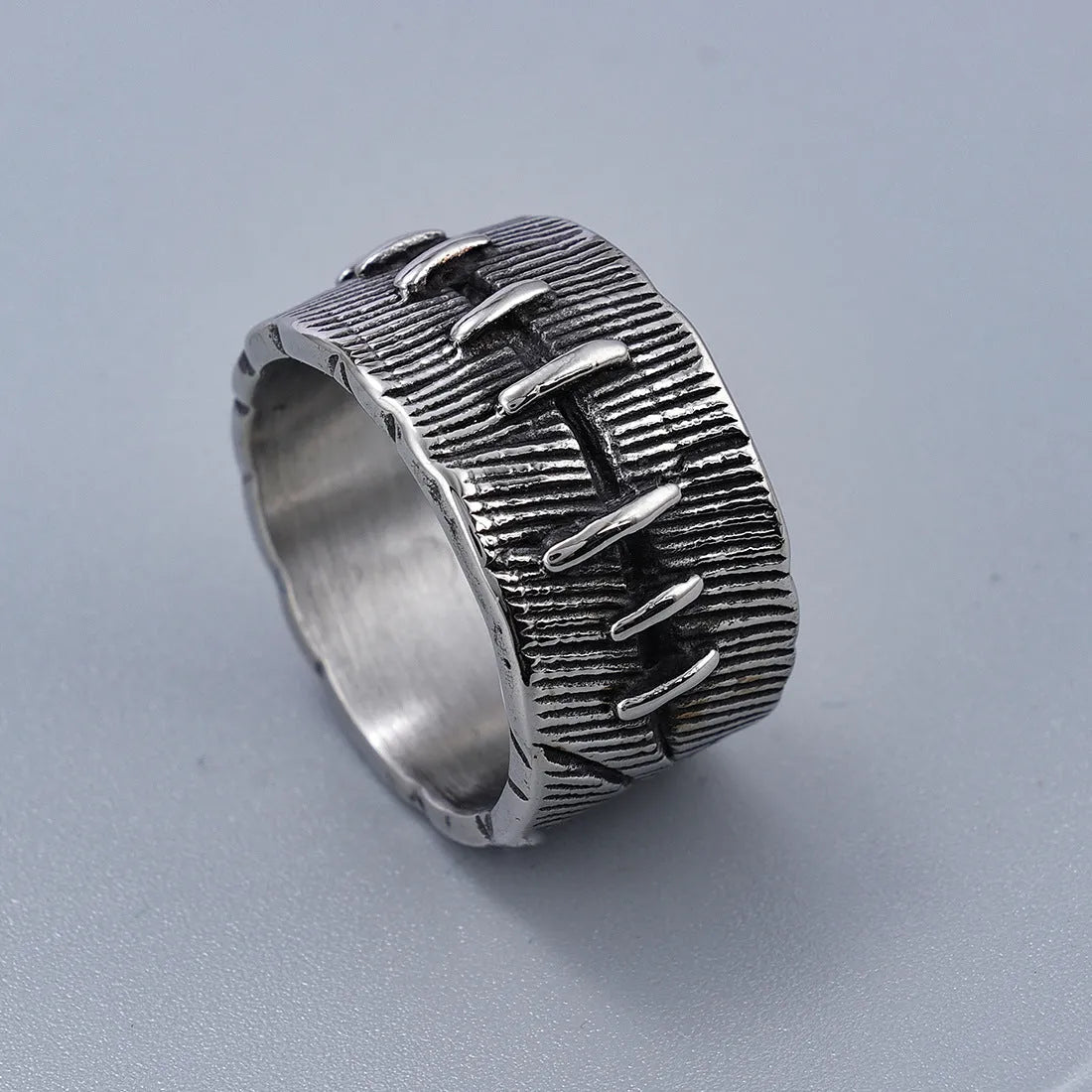 Geometric titanium steel double ring with U-shape design in retro colour on a hand.