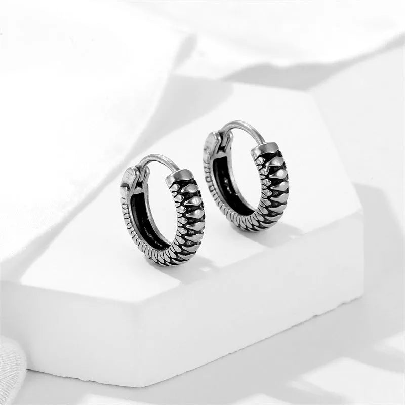 Silver geometric striped drop earrings with retro twist design and round sports-style elements