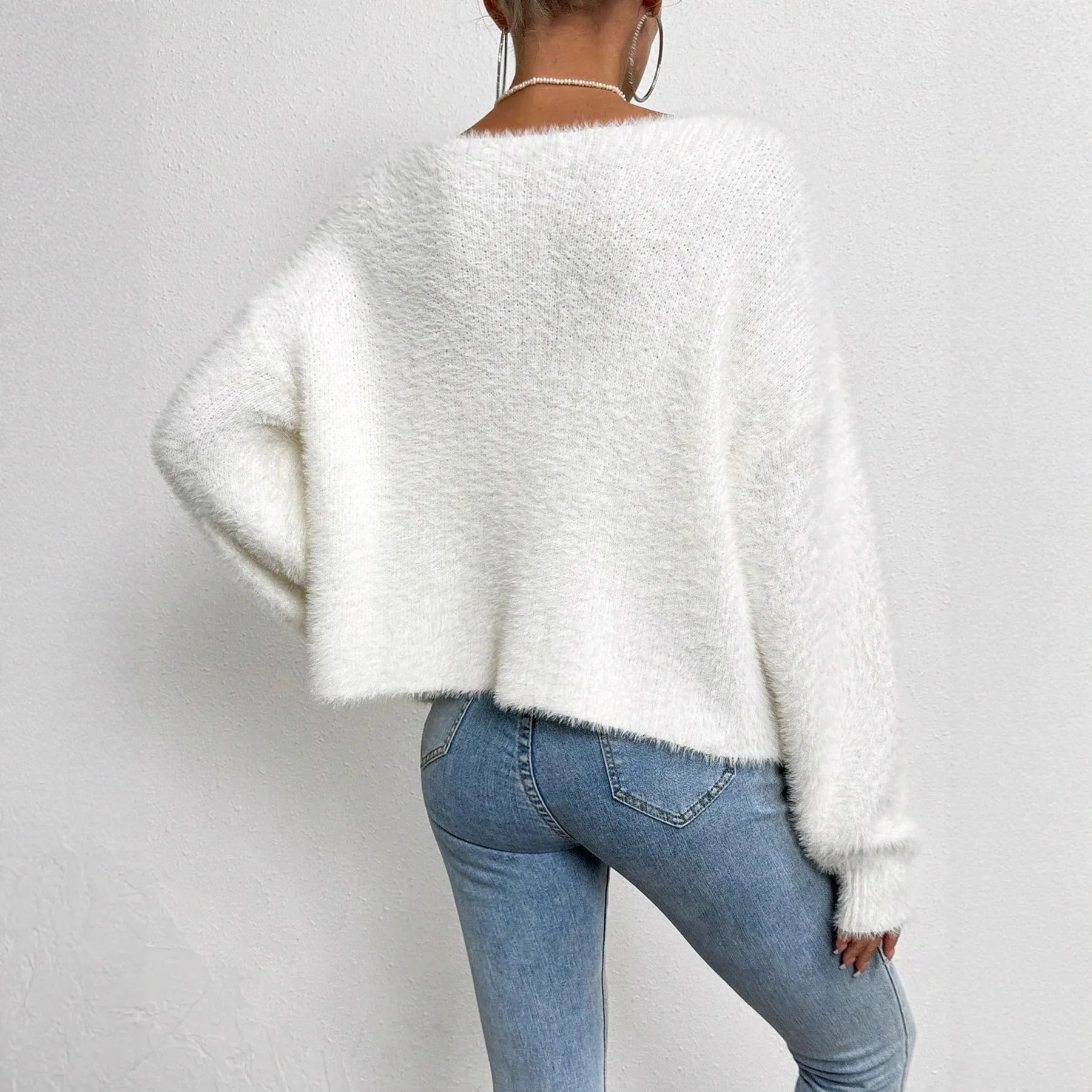 White women's V-neck cardigan with bead details, shown as a knitwear coat.