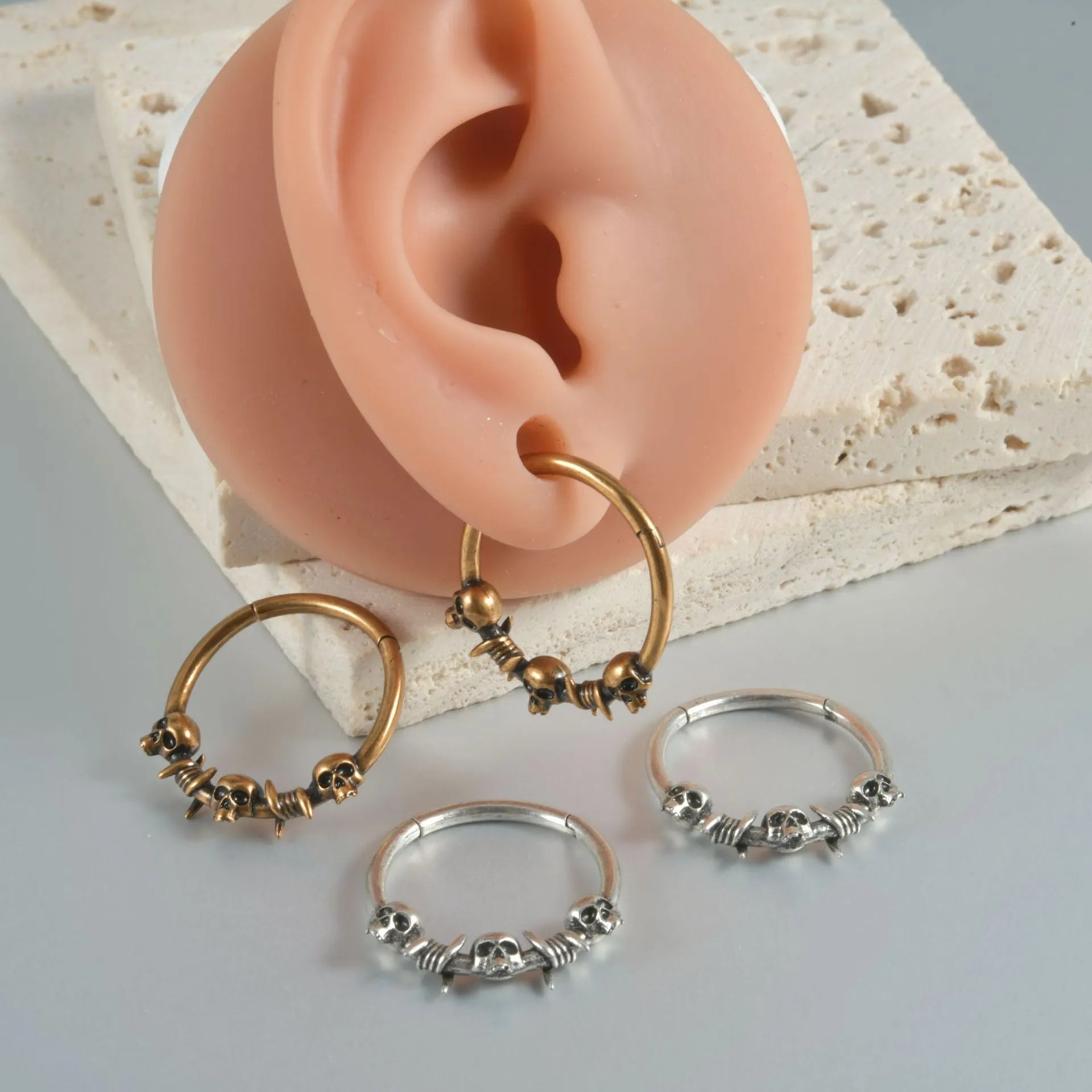 Copper punk earring with detailed ghost head design in antique silver finish for pierced ears