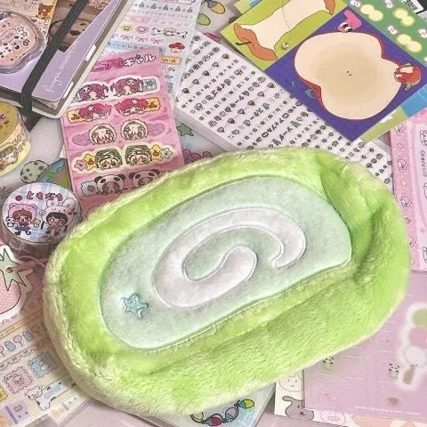 Grey and cream Swiss roll cake design velvet pencil case rolled up with pens visible