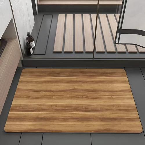 American-style square bath mat with wood grain pattern on a bathroom floor.