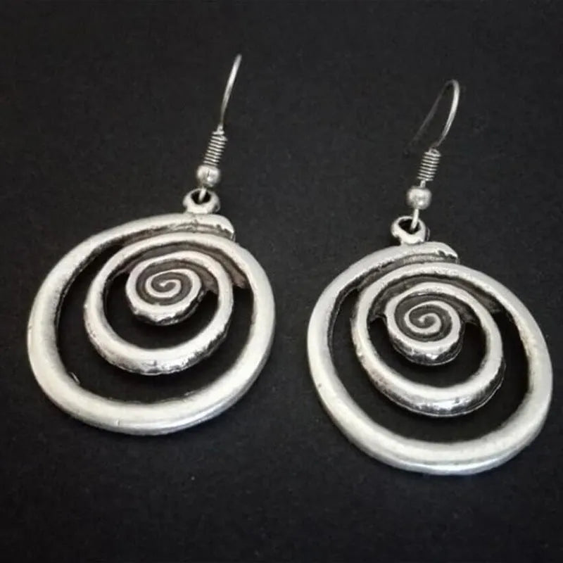 Silver geometric spiral earrings with distressed finish and vintage ethnic style design