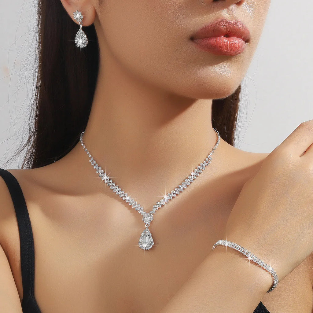 Women's rhinestone water drop necklace and earrings set on a claw chain in blue colour.