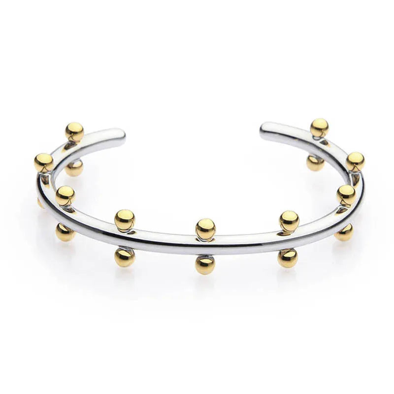Stainless steel C-shaped bracelet with textured bean beads in gold finish.