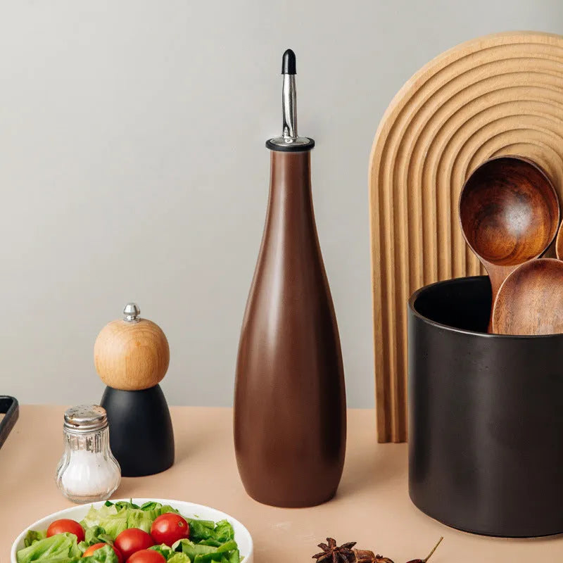 Ceramic oil pot with funnel lid and integrated brush in kitchen setting