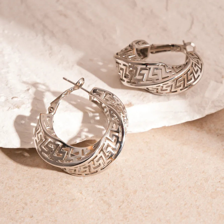 Women's twisted geometric hollow stud earrings in gold and silver electroplated finishes