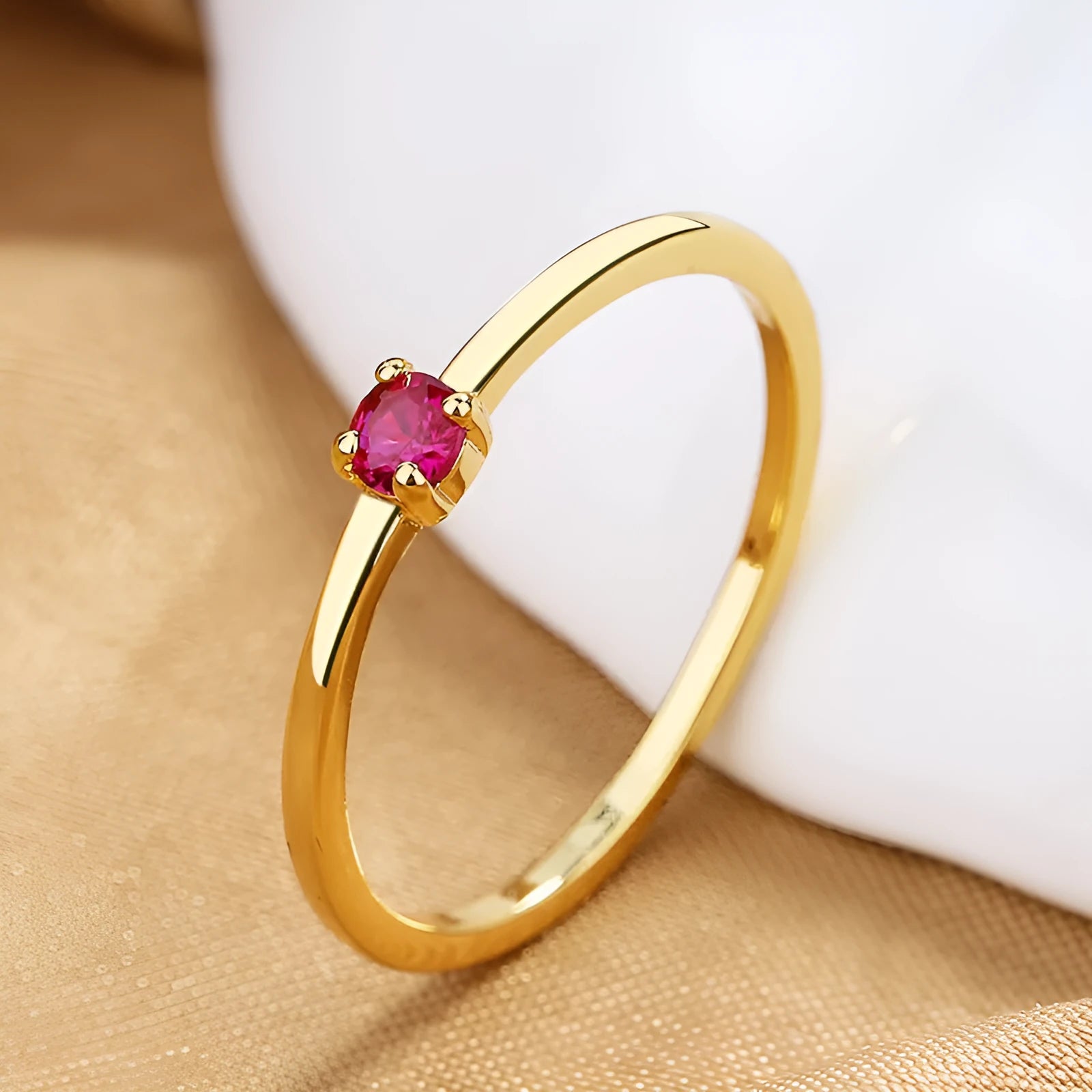 Copper geometric ring with a single diamond shape on a round band, shown in white, red, green, and blue colour options.