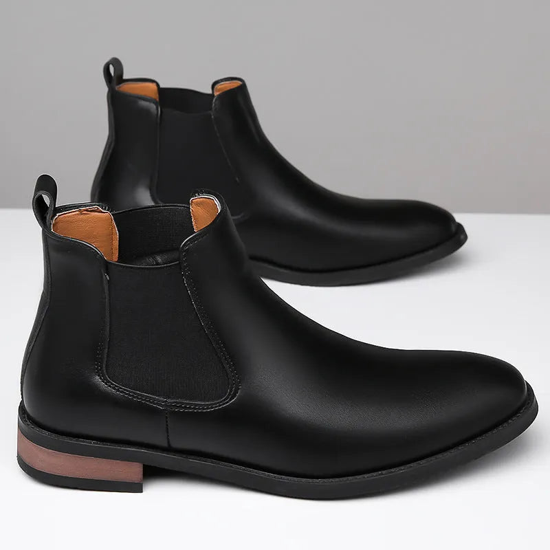 Men's black Chelsea boots with round toe, low heel, and mid-calf shaft made from artificial PU leather