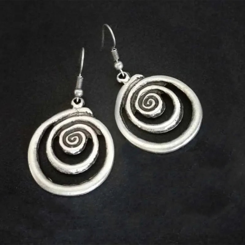 Silver geometric spiral earrings with distressed finish and vintage ethnic style design