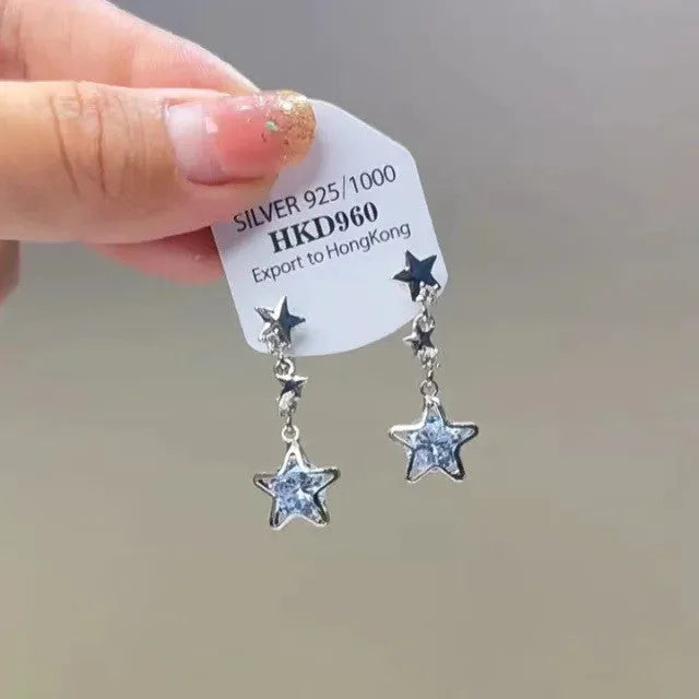 Geometric alloy clip-on earrings with rhinestone stars, a heart design, and dangling tassels.