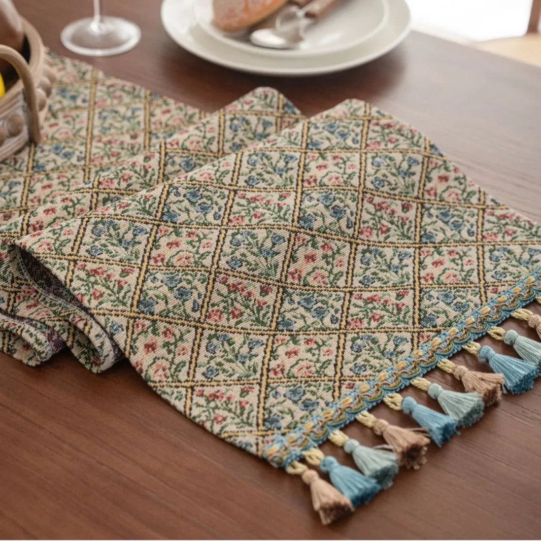 Dark blue Nordic Jacquard bouquet pattern table runner with tassel trim, 32cm wide.