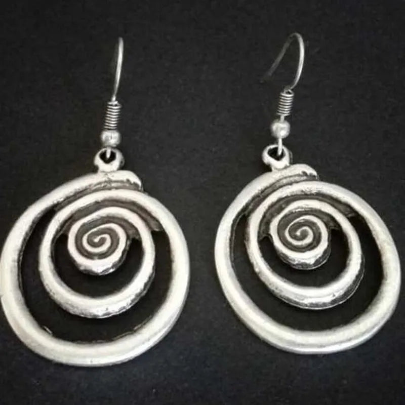 Silver geometric spiral earrings with distressed finish and vintage ethnic style design