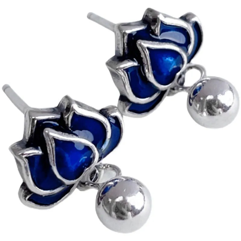 Blue alloy lotus seedpod earrings with tassel detail, shown as a pair of dangle drop studs.