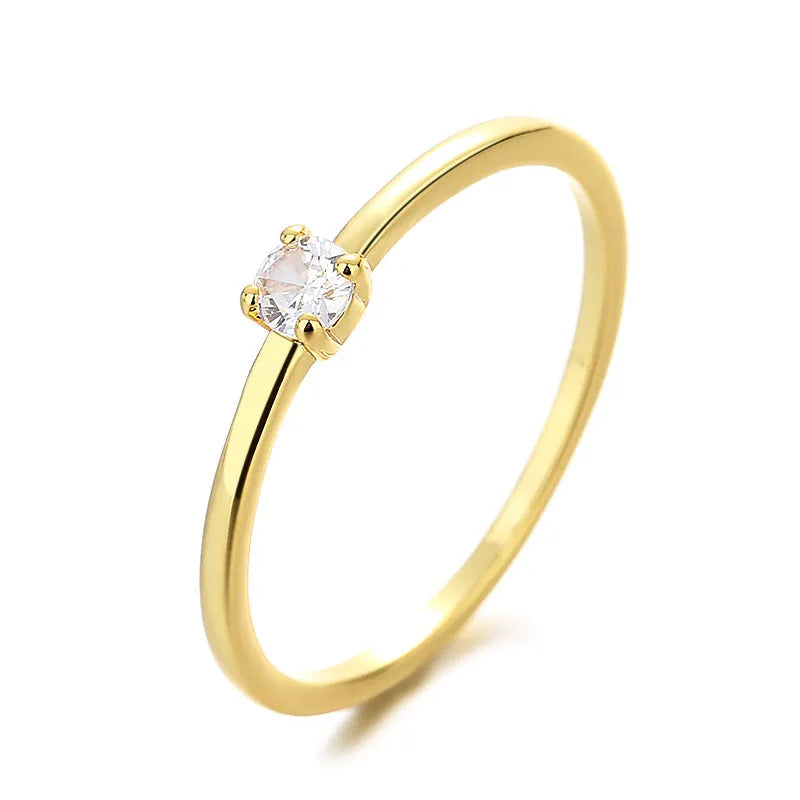 Copper geometric ring with a single diamond shape on a round band, shown in white, red, green, and blue colour options.
