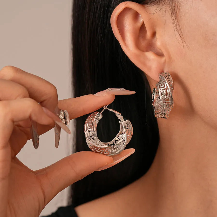 Women's twisted geometric hollow stud earrings in gold and silver electroplated finishes