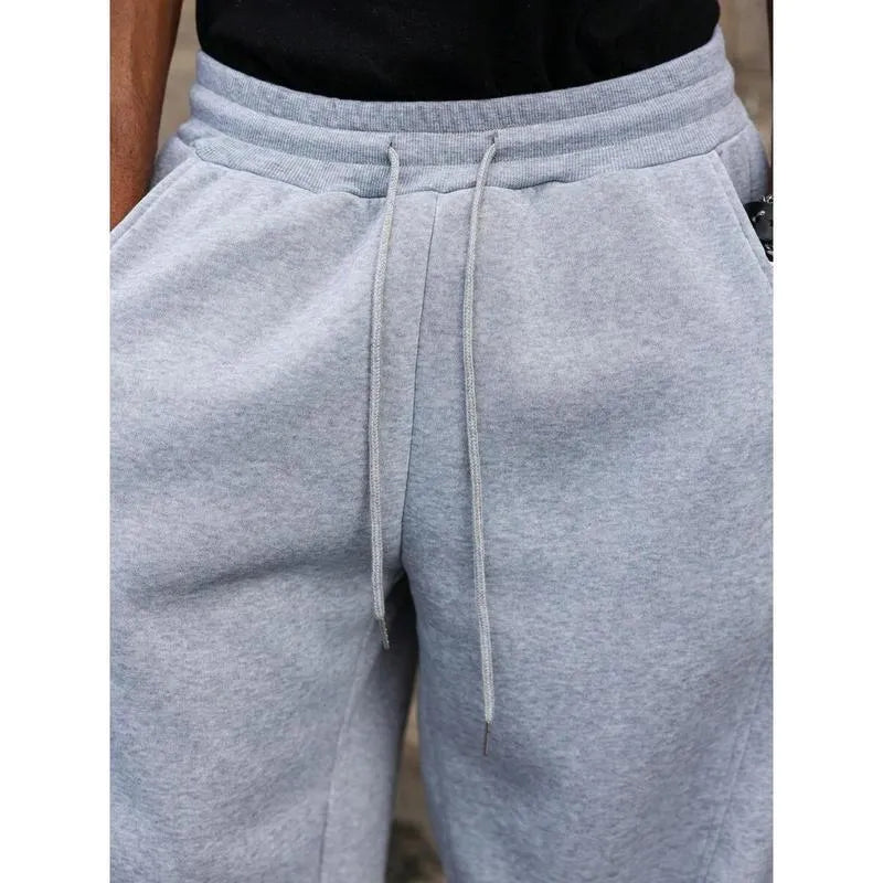 Man wearing dark grey high-waist straight-leg casual trousers made from elastic bamboo fibre fabric.