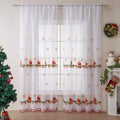 Christmas curtains with white snowflake embroidery on red polyester fabric hanging in window