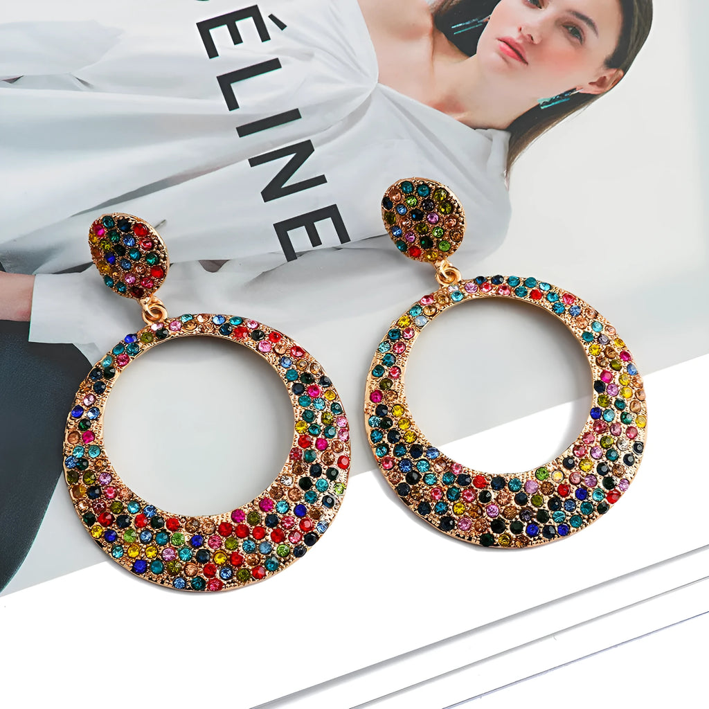 Large circular pendant earrings with diamond accents in colourful cartoon style design