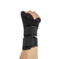 Black carbon fibre pattern wrist guard with grey edging and a white thumb strap, shown on a left hand.