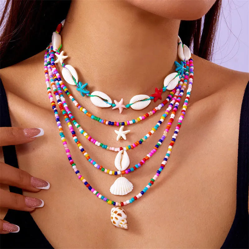 Five women's necklaces with starfish, shell and conch bead pendants on adjustable chains