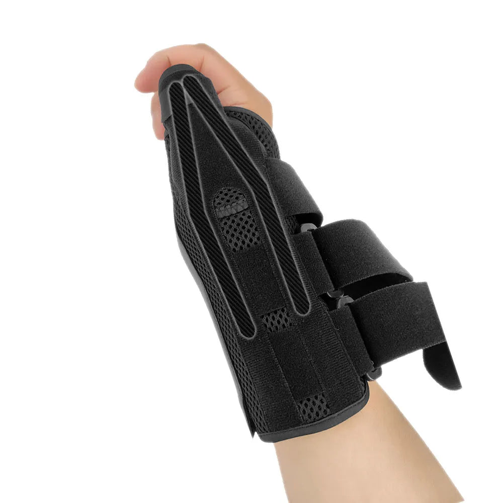 Black carbon fibre pattern wrist guard with grey edging and a white thumb strap, shown on a left hand.