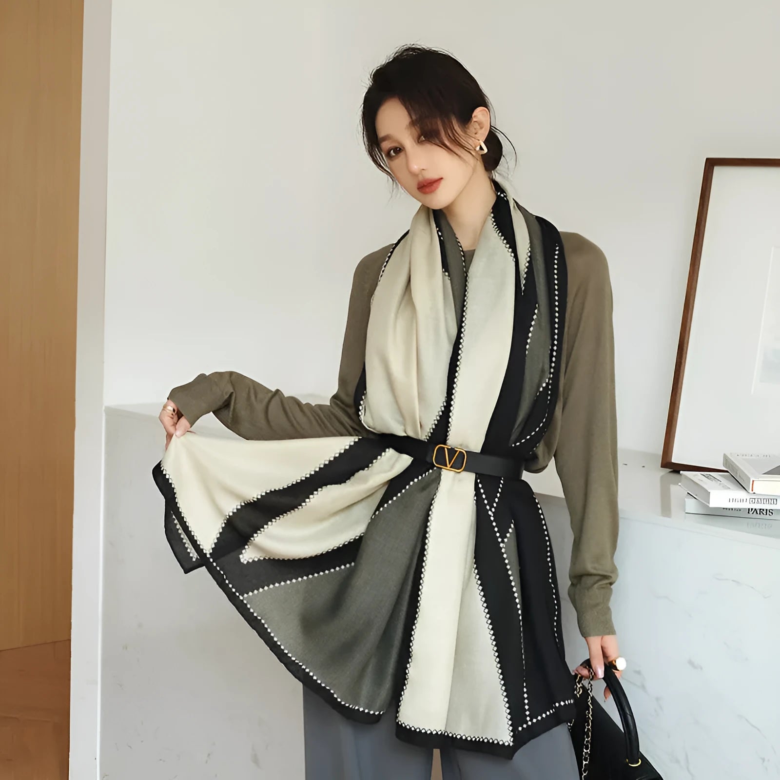 A woman wearing a printed polyester shawl measuring 180cm by 90cm.