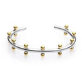 Stainless steel C-shaped bracelet with textured bean beads in gold finish.