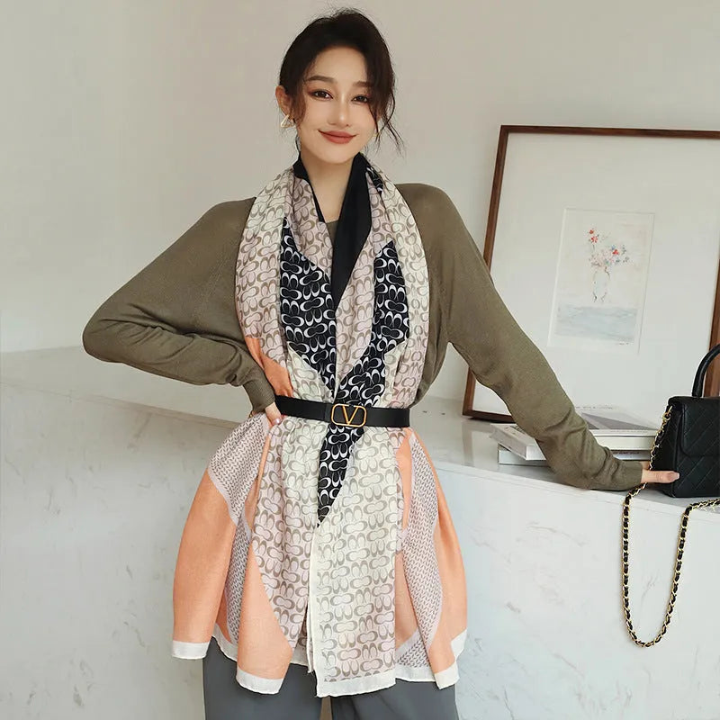 A woman wearing a printed polyester shawl measuring 180cm by 90cm.