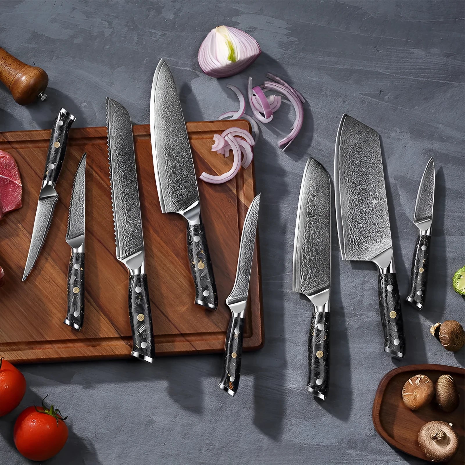Damascus steel eight-piece kitchen knife set showing fishbone pattern on blades, including fruit, steak, boning, and chef's knives.
