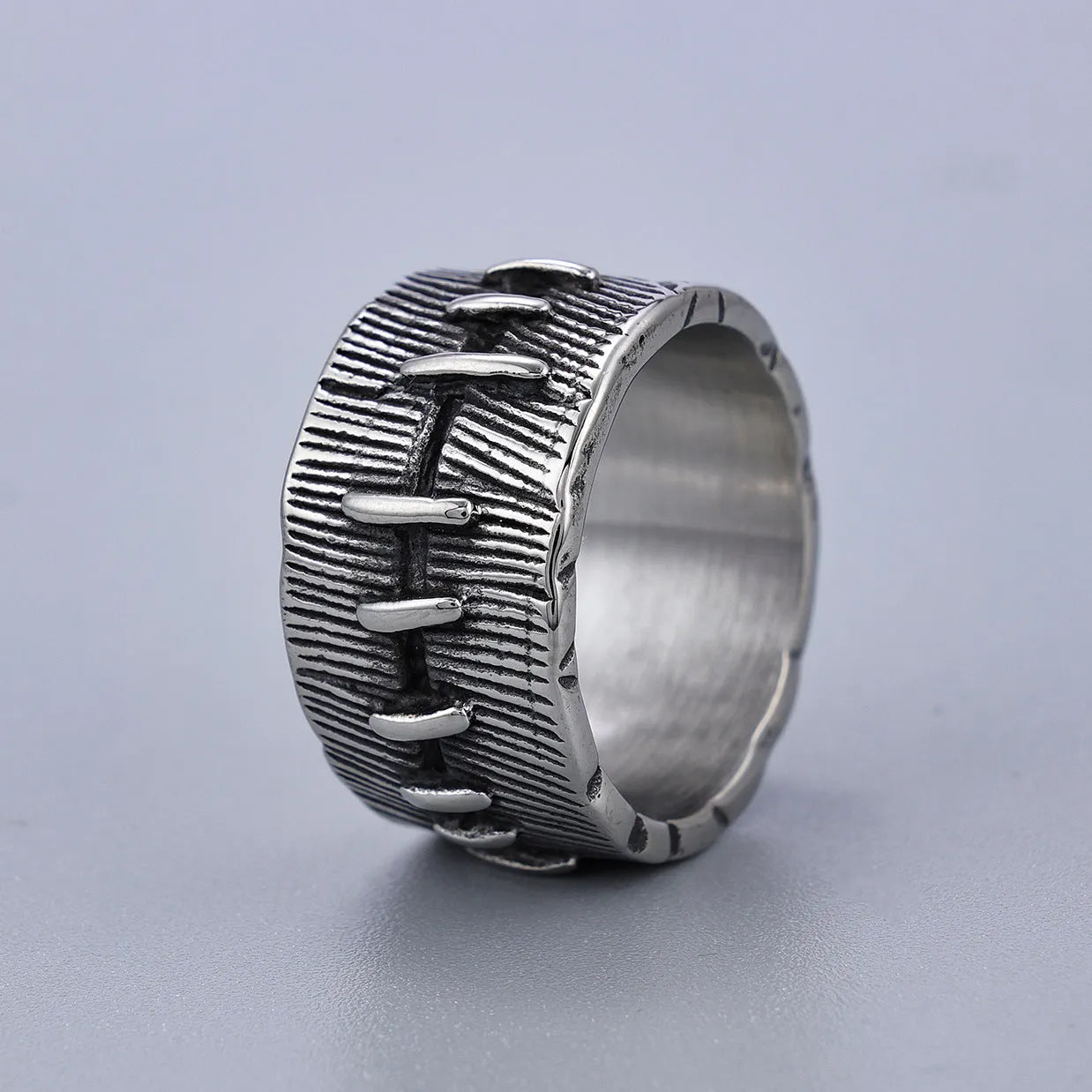 Geometric titanium steel double ring with U-shape design in retro colour on a hand.