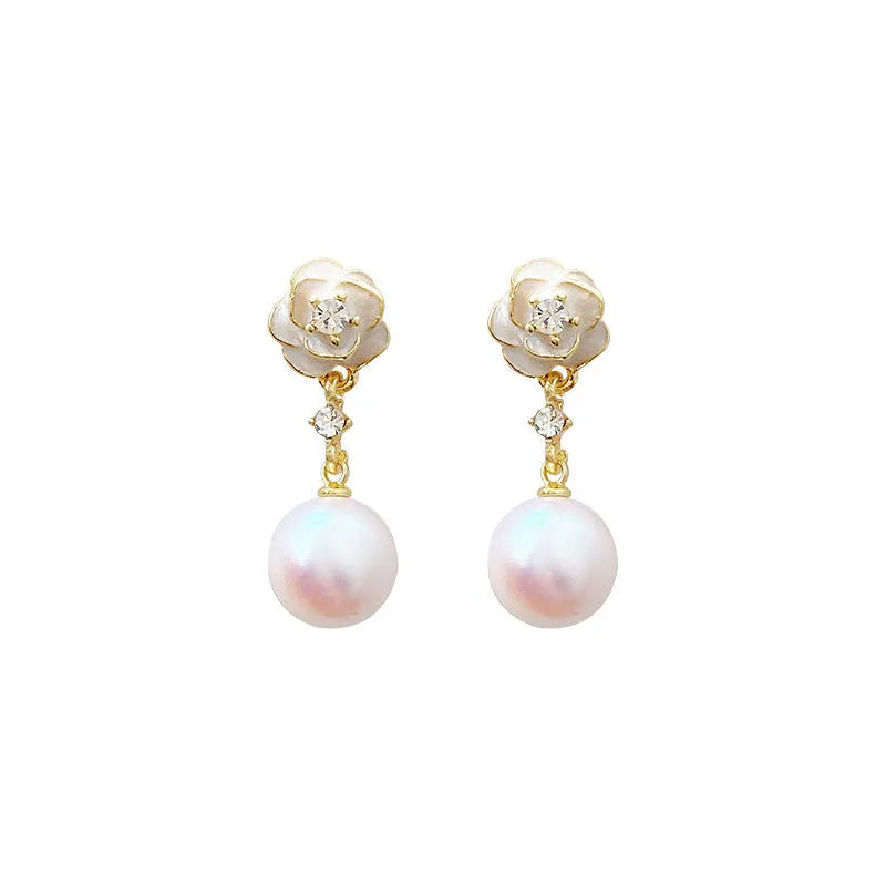 A pair of alloy camellia flower stud earrings for women with a faux pearl centre.
